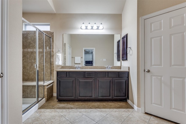 bathroom featuring tile patterned floors, an enclosed shower, and vanity