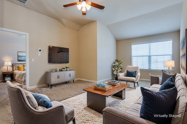 living room with ceiling fan, light colored carpet, and vaulted ceiling