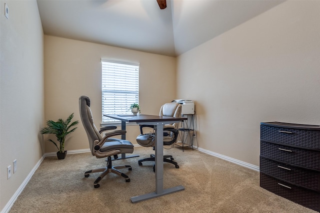 carpeted home office featuring vaulted ceiling and baseboards