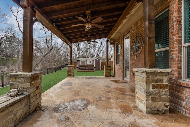 view of patio / terrace with a storage unit and ceiling fan