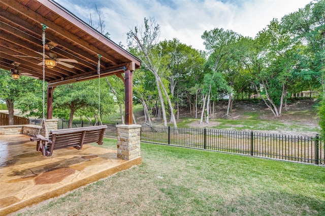 view of yard featuring ceiling fan and a patio