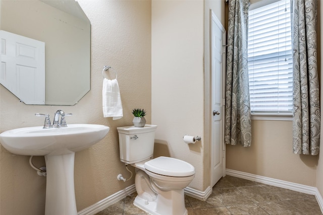 bathroom with a healthy amount of sunlight and toilet