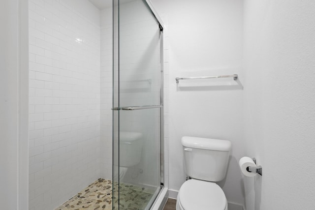 bathroom with walk in shower and toilet