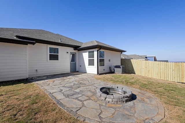 back of property featuring an outdoor fire pit, a yard, cooling unit, and a patio area