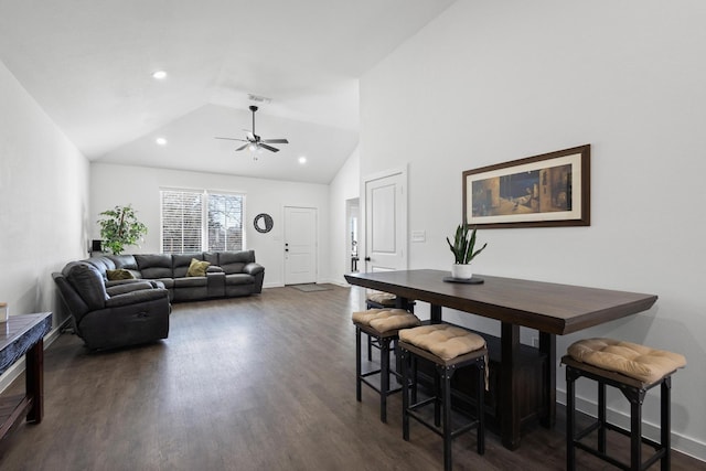 dining area with dark wood-type flooring, ceiling fan, and vaulted ceiling