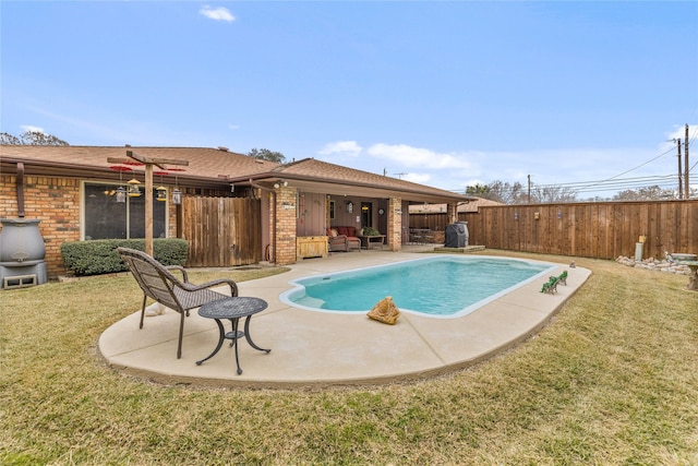 view of swimming pool with a patio area, a lawn, a fenced backyard, and a fenced in pool