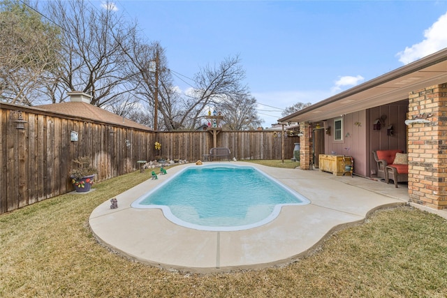 view of swimming pool featuring a yard and a patio area