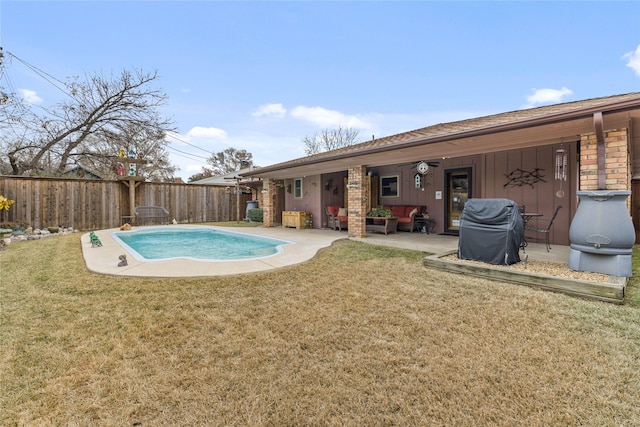 view of swimming pool featuring a patio area, grilling area, and a lawn