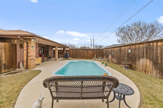 view of swimming pool with a patio area, a fenced in pool, a yard, and a fenced backyard