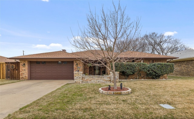 ranch-style house with brick siding, an attached garage, concrete driveway, and a front yard