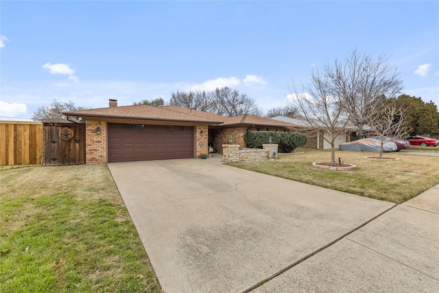 view of front of home with a front yard, driveway, a chimney, a garage, and brick siding