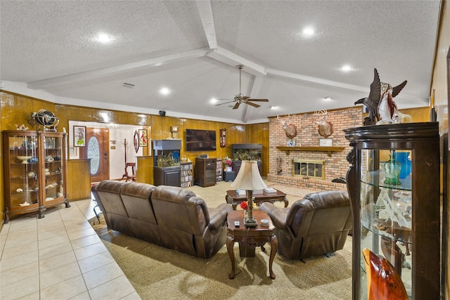 living room featuring a textured ceiling, light tile patterned flooring, wood walls, a fireplace, and vaulted ceiling with beams