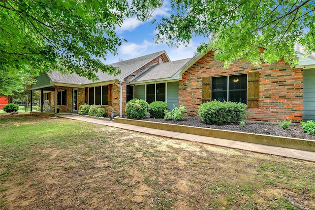 ranch-style home with a front lawn