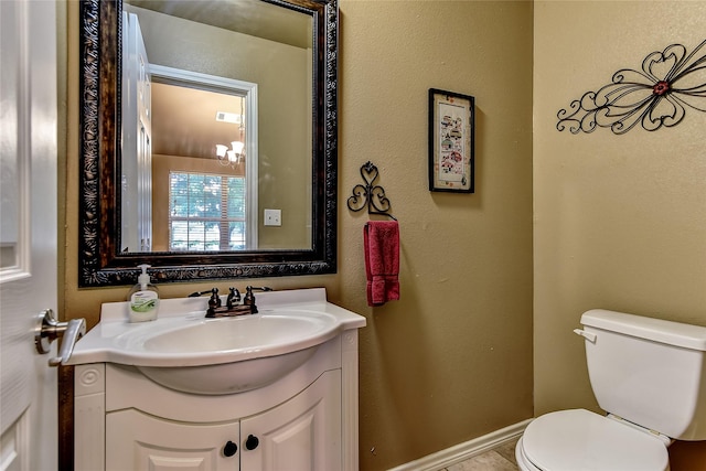 bathroom with toilet and vanity