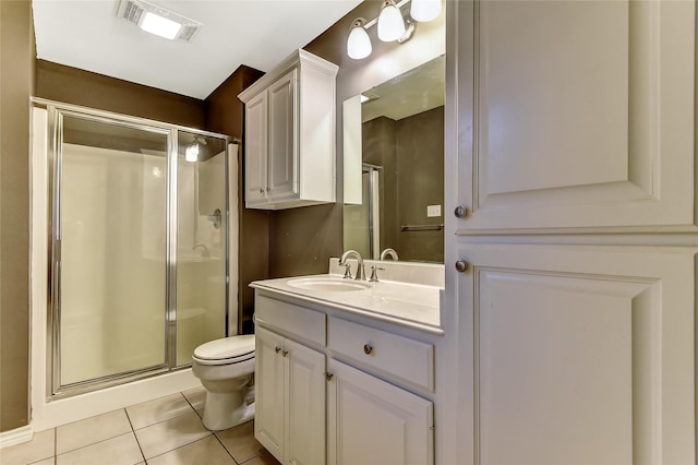 bathroom featuring walk in shower, vanity, tile patterned flooring, and toilet