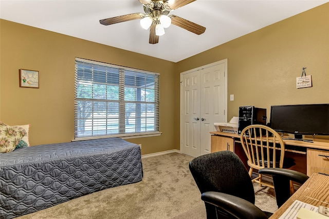 carpeted bedroom featuring ceiling fan and a closet