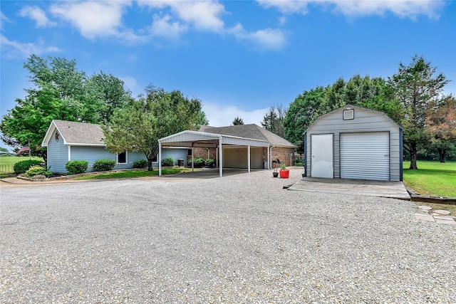 view of front of home featuring a garage, an outdoor structure, and a carport