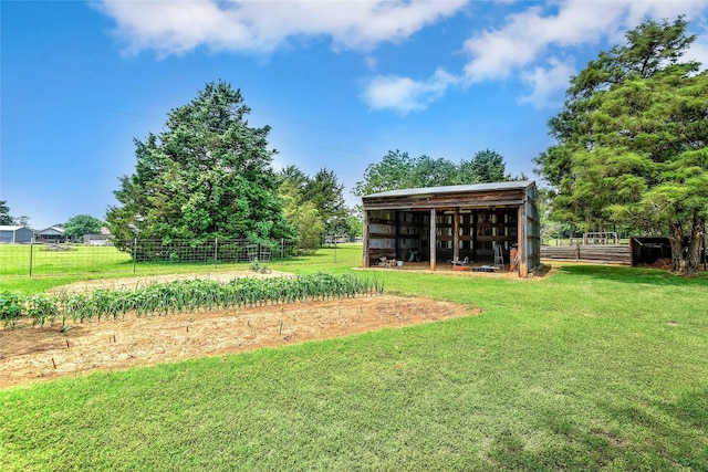 view of yard with an outbuilding and a rural view