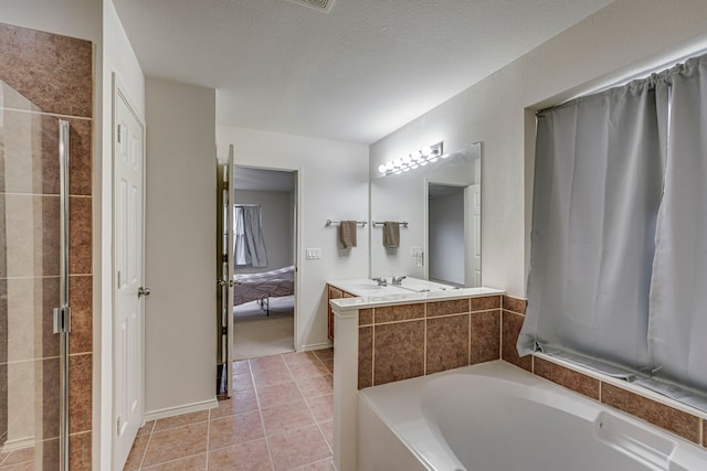 bathroom with tile patterned floors, separate shower and tub, and vanity