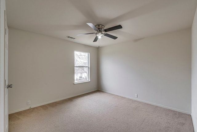 empty room featuring ceiling fan and light colored carpet