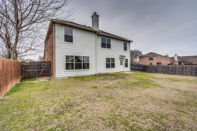 rear view of property with a lawn