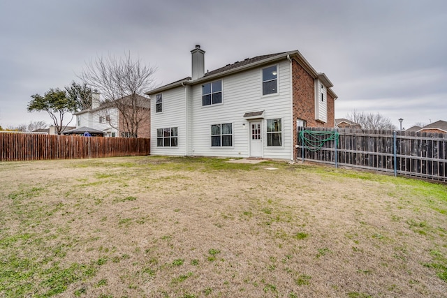 back of house featuring a yard