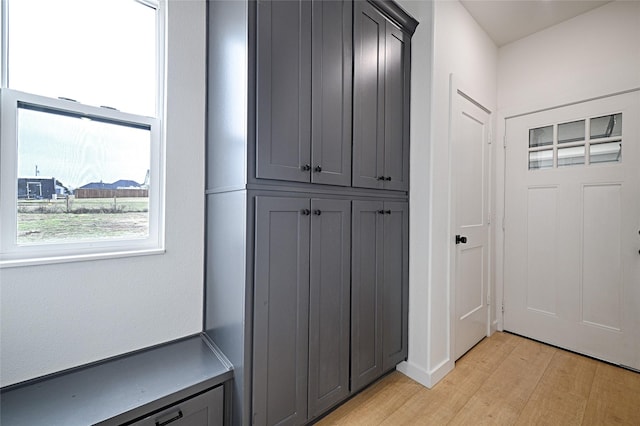 mudroom with light hardwood / wood-style floors