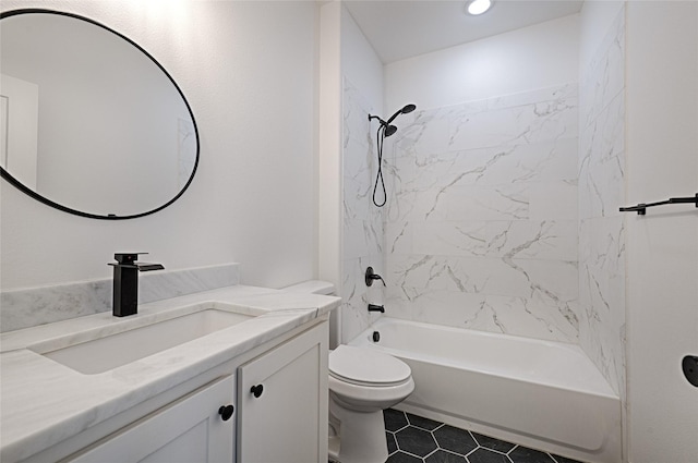 full bathroom featuring tiled shower / bath combo, vanity, toilet, and tile patterned flooring