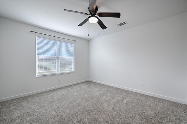 empty room with ceiling fan and carpet flooring