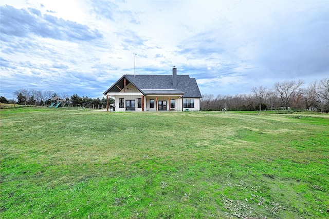 view of front facade with a playground and a front yard