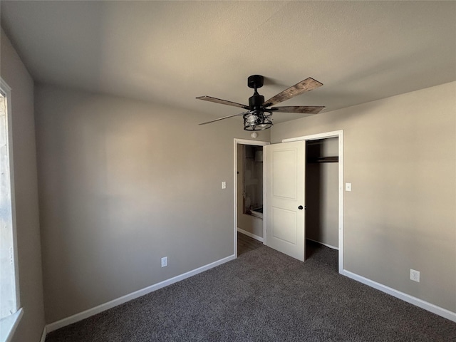 unfurnished bedroom with ceiling fan, a closet, and dark colored carpet