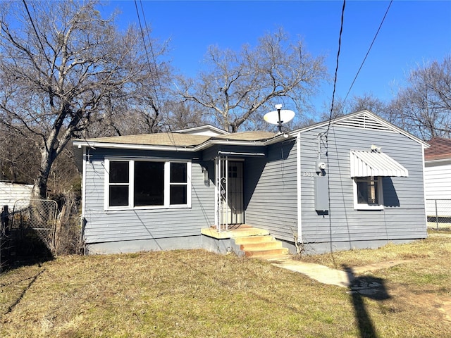 bungalow-style house with a front lawn