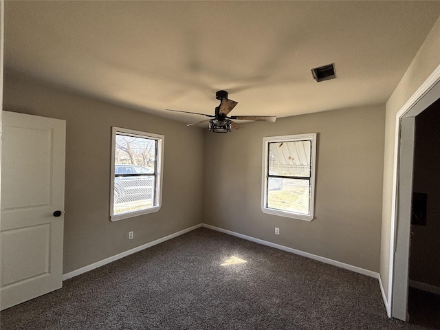 carpeted empty room featuring ceiling fan and a healthy amount of sunlight