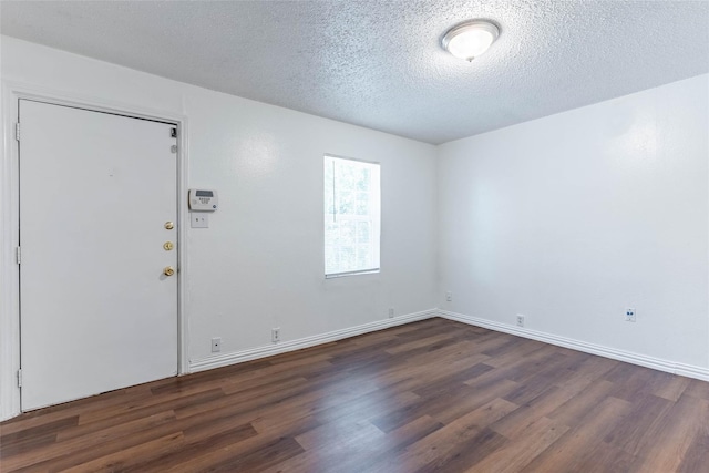 entryway with dark hardwood / wood-style floors and a textured ceiling