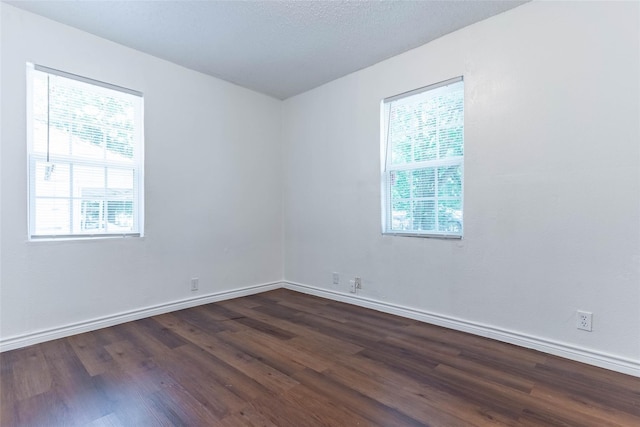 unfurnished room featuring dark hardwood / wood-style floors