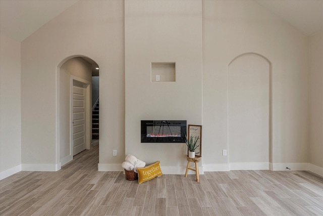 unfurnished living room featuring vaulted ceiling