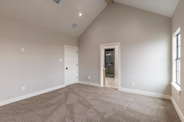 carpeted empty room featuring a healthy amount of sunlight, beam ceiling, and high vaulted ceiling