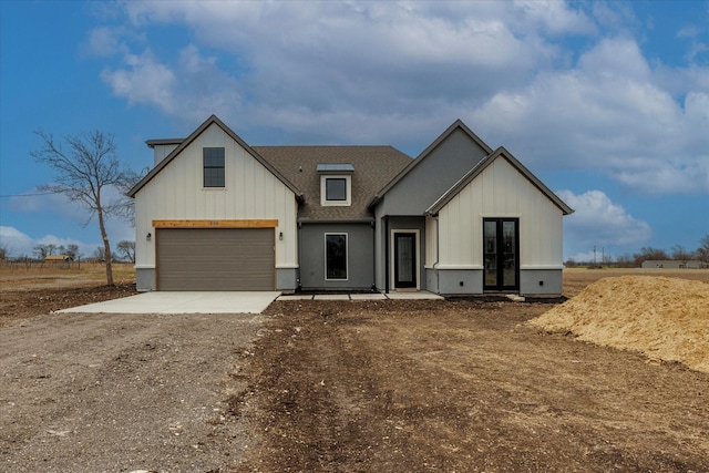 modern inspired farmhouse with a garage