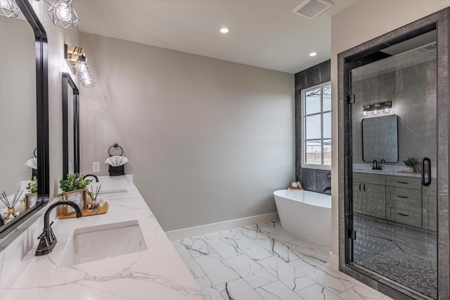 bathroom with vanity and shower with separate bathtub