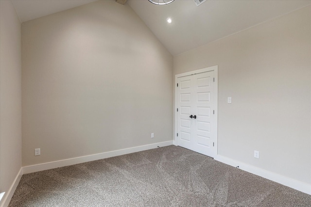 unfurnished room featuring vaulted ceiling with beams and carpet floors