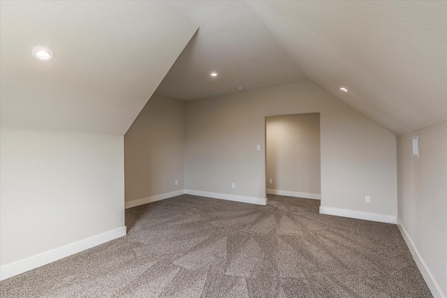 additional living space with carpet and vaulted ceiling