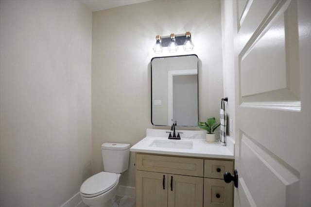 bathroom featuring toilet and vanity