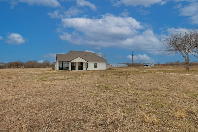 exterior space with a lawn and a rural view