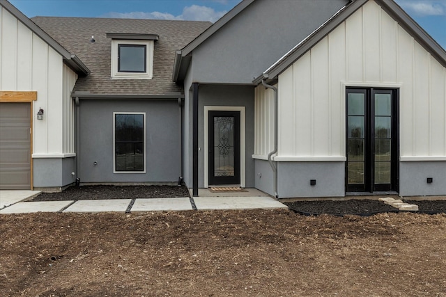 doorway to property with a garage