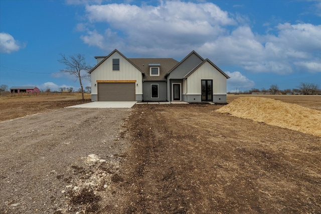 modern farmhouse style home with a rural view and a garage