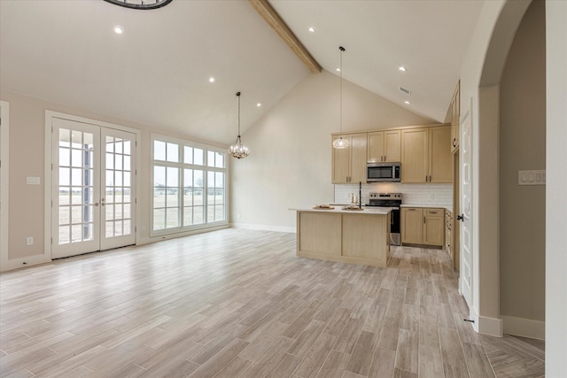 kitchen with stainless steel appliances, decorative backsplash, light brown cabinets, hanging light fixtures, and beamed ceiling