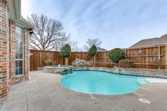 view of swimming pool featuring an in ground hot tub, pool water feature, and a patio