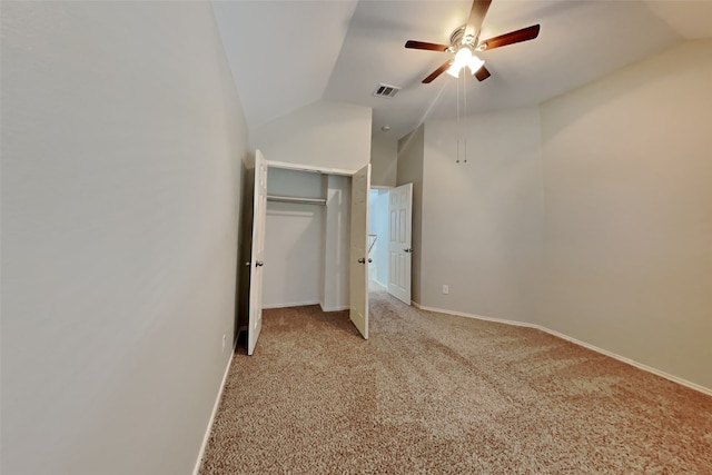 unfurnished bedroom with ceiling fan, light carpet, and vaulted ceiling