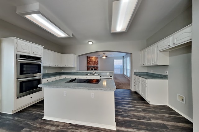 kitchen featuring white cabinetry, black electric stovetop, dark hardwood / wood-style flooring, double oven, and sink