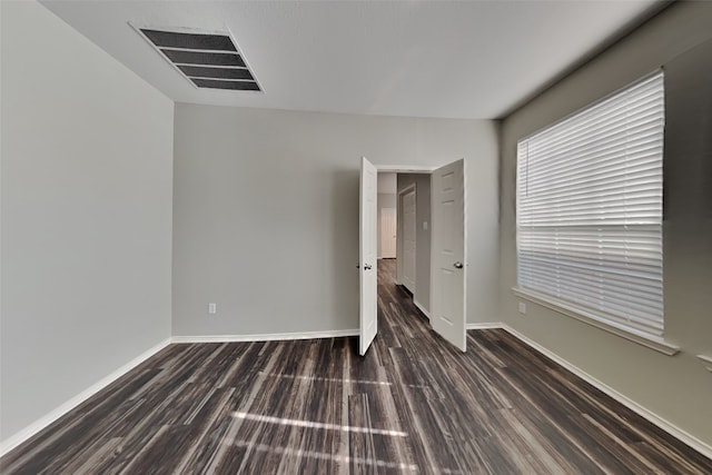 spare room with dark hardwood / wood-style flooring